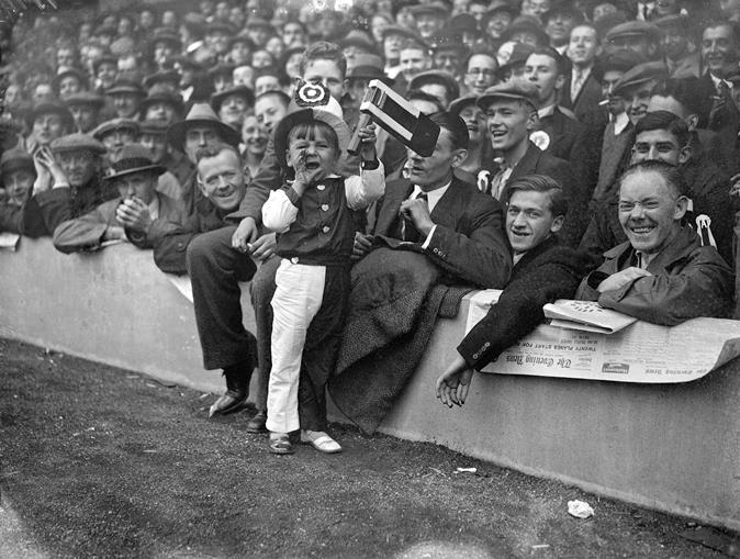 A young gooner before the Arsenal v Tottenham Hotspur Football Club game at Highbury Stadium in London. October 20, 1934